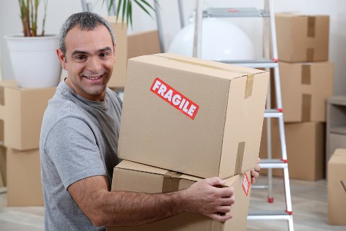 Careful lifting of bulky furniture during a Brent flat removal