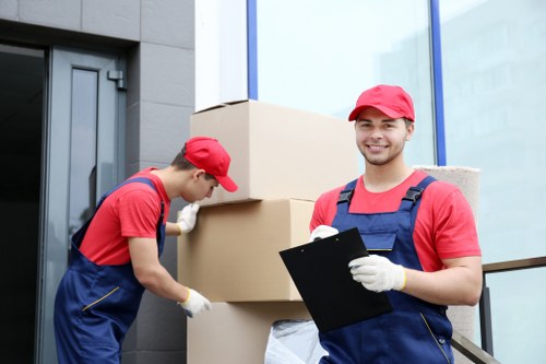 Professional house removalists in Brent loading furniture into a removal van