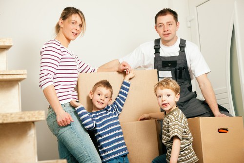 Professional removal team working safely with boxes and furniture