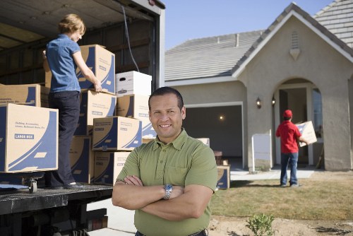 Brent man and van loading boxes into a moving vehicle