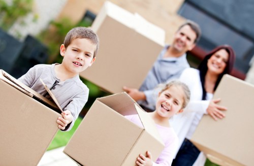 Staff handling boxes and furniture with care during a removal job