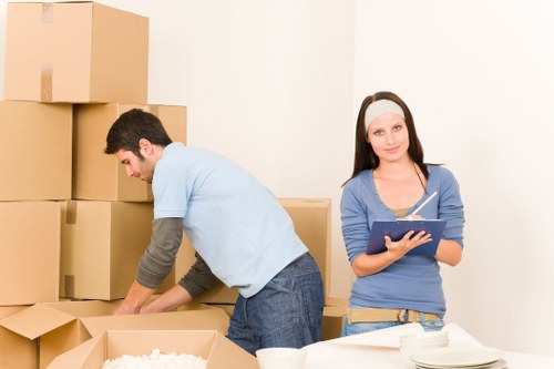 Professional movers protecting furniture during a Brent relocation