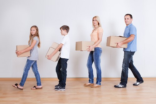 Professional movers preparing items for transport in Brent